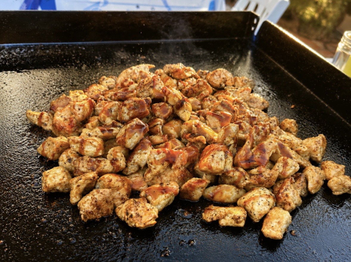 Organic air-chilled chicken searing on the griddle